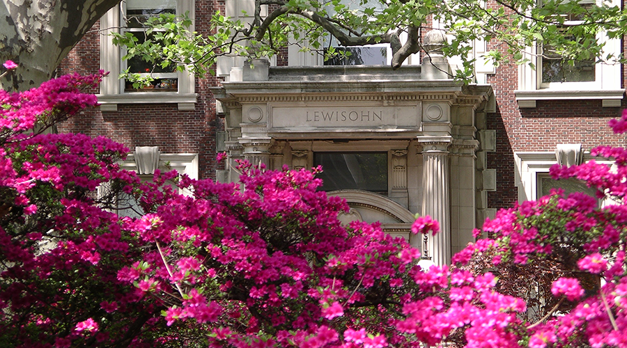Outside of Lewisohn Hall with pink flowers blooming. 