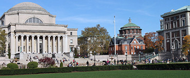 The lawn of Low Library with students sitting and walking around campus.