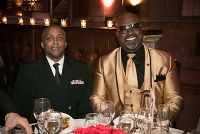 Two attendees smile for the camera at their table