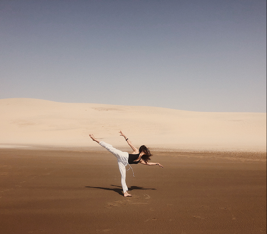 Incoming student Neyla Belmaachi dances in front of a desert backround