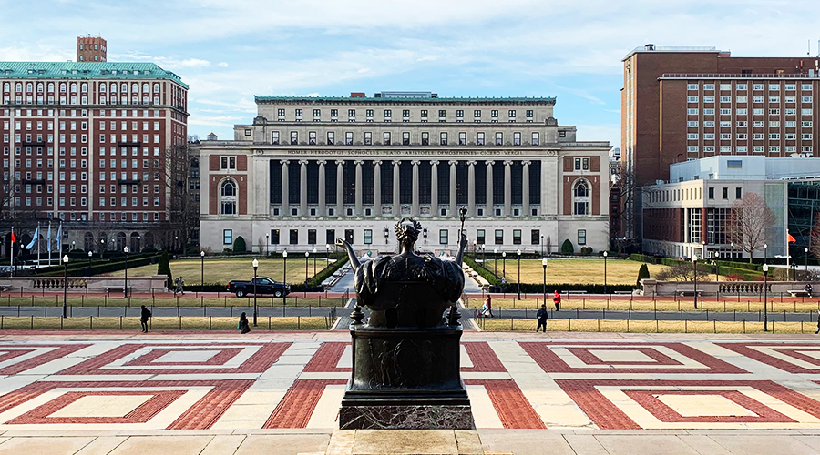 Butler Library as seen from the steps of Low Library, with the Alma Mater statue in the foreground
