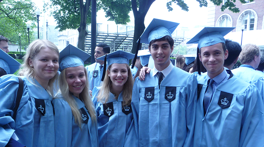 Five graduates in their blue Columbia gowns and caps