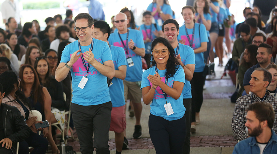 New student orientation leaders cheer as they enter the tents for the New Student Welcome