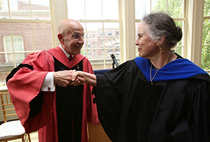 Dean Peter J. Awn and Professor Deborah Mowshowitz perform the secret PBK handshake