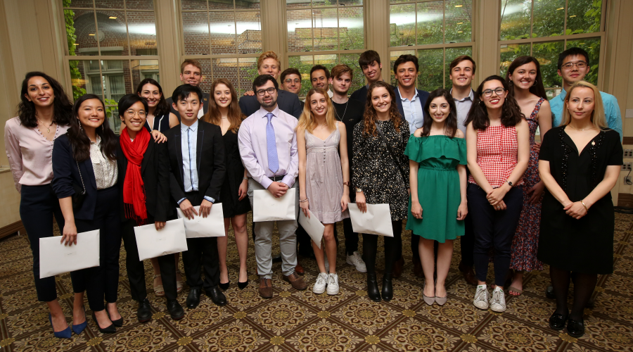 A group of 22 Phi Beta Kappa inductees pose for a photo at Faculty House