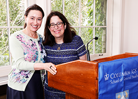 Alumnae Allison Fillmore '97 and Dean Rosen-Metsch '90 pose for a photo at the podium