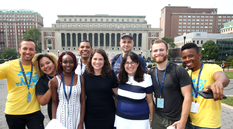 Dean Lisa Rosen-Metsch and Dean of Students Ivonne Rojas pose with incoming students and Orientation leaders with Butler Library in background