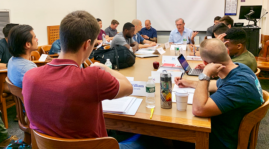 Professor Eric Foner leads a small-group discussion with students seated at a table