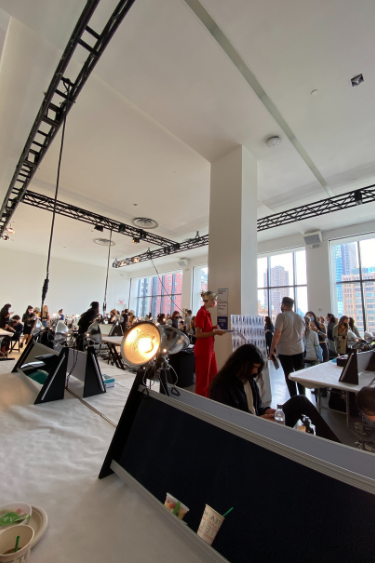 A large room filled with people working on Rachel Comey's NYFW Show.