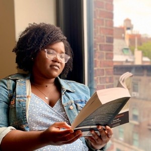 Columbia GS student Sacha Telfer reading by a window.