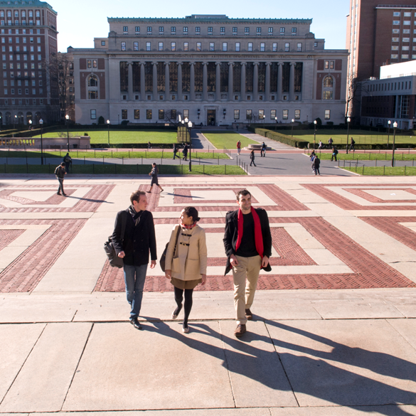 Students walking on campus with Butler Library in background